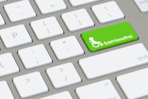 Grünes Barrierefrei Symbol auf Computer Tastatur